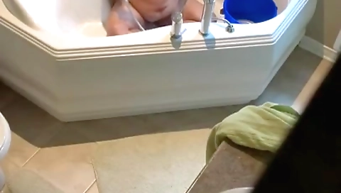 Busty brunette naked in a bikini and shows off her boobs