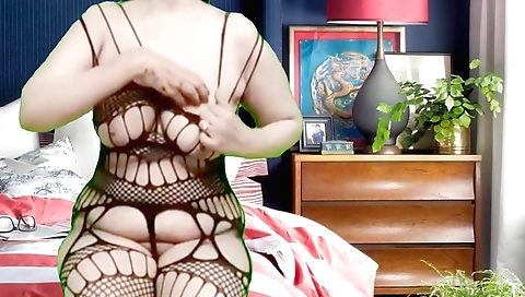 Busty brunette in a dress and stockings enjoys pussy