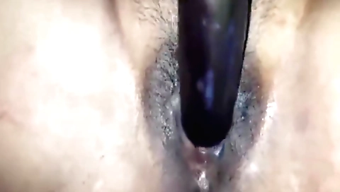 Indian babe gets her hairy pussy and clit filled with a toy