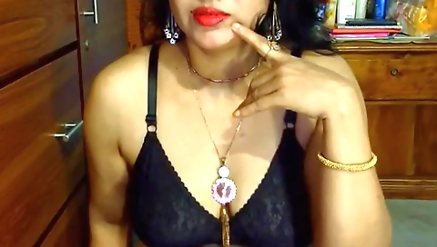 Indian hottie is naked and poses in front of the camera